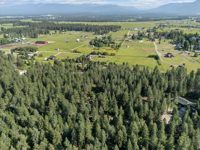 Aerial view of property and surrounding area with a mountainous background | Image 36