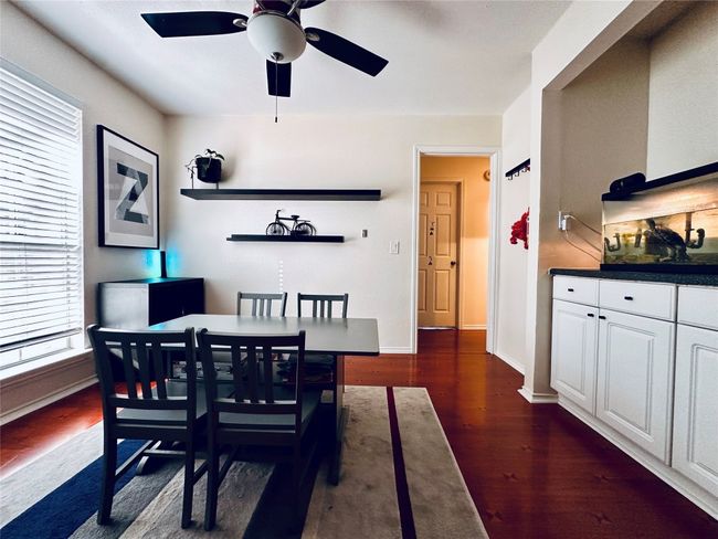 Dining room featuring dark wood-style floors, baseboards, and a ceiling fan | Image 11