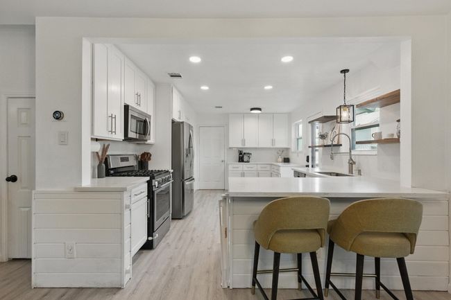 The updated kitchen design includes a functional layout that maximizes space while maintaining an elegant, modern feel. | Image 9
