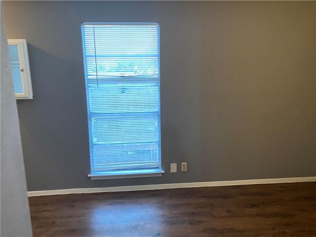 Spare room with baseboards and wood finished floors | Image 7