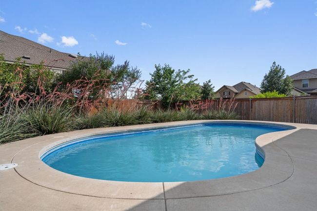 View of swimming pool featuring a fenced backyard | Image 27