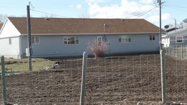 Back of house with roof with shingles and fence | Image 17