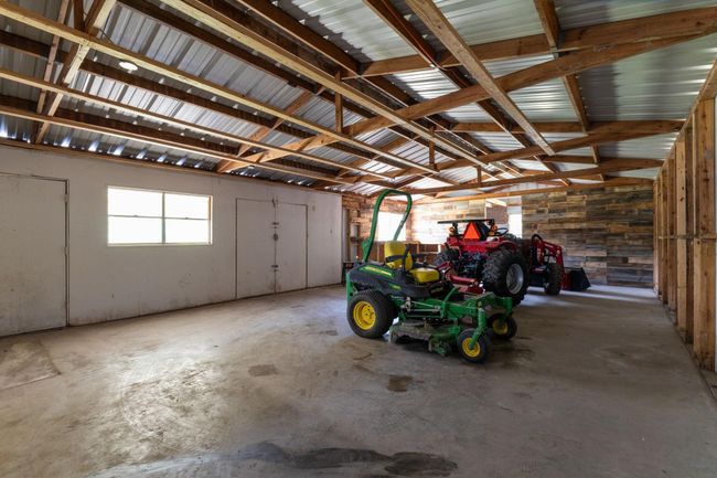 Spacious workshop with high ceilings, ample natural light, and versatile storage options—perfect for projects and equipment storage. | Image 44