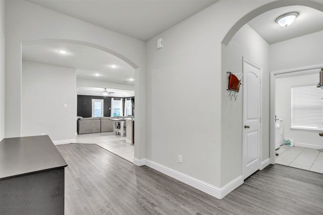Hall featuring arched walkways, wood finished floors, and recessed lighting | Image 10