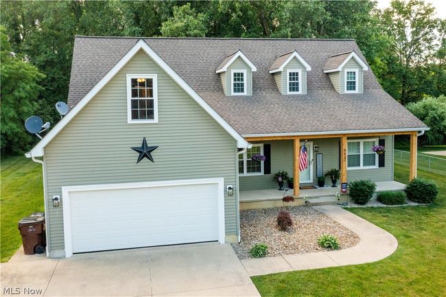 View of front of property with a garage and a front yard | Image 44