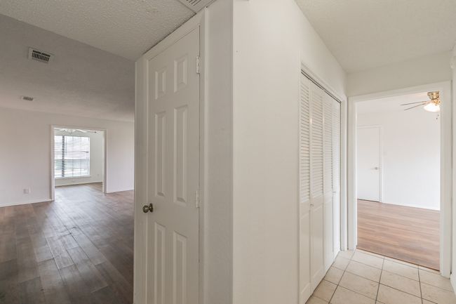 Hallway with light wood finished floors and baseboards | Image 12