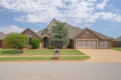 View of front of home with a garage and a front yard | Image 1