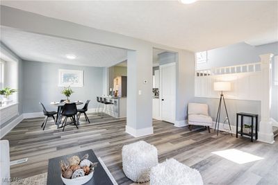 Living room featuring a wealth of natural light, a textured ceiling, and hardwood / wood-style flooring | Image 2