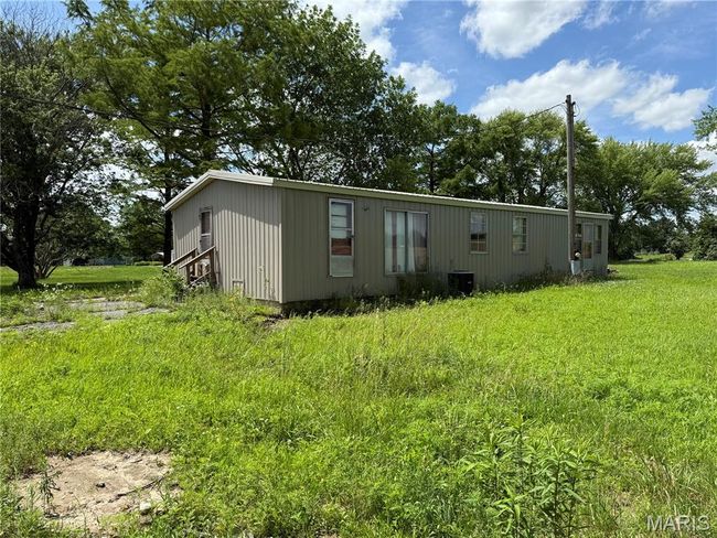View of home's exterior with a central air condition unit | Image 4
