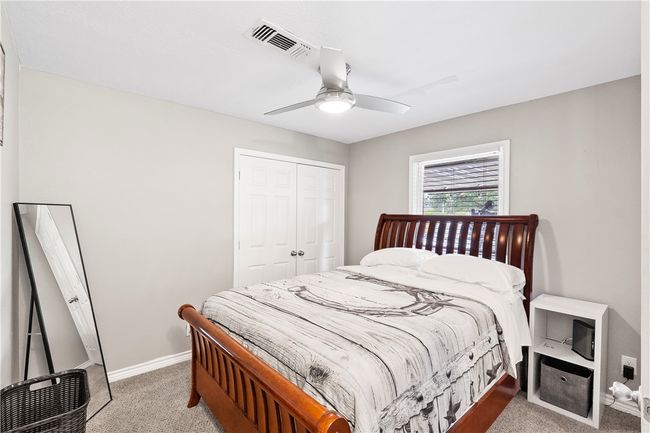 Bedroom featuring light carpet, a closet, and a ceiling fan | Image 22