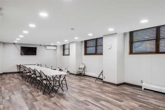 Dining area with baseboards, wood finished floors, a wall mounted AC, and recessed lighting | Image 16
