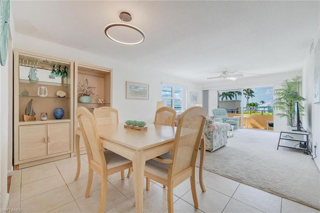 Carpeted dining area featuring ceiling fan | Image 11
