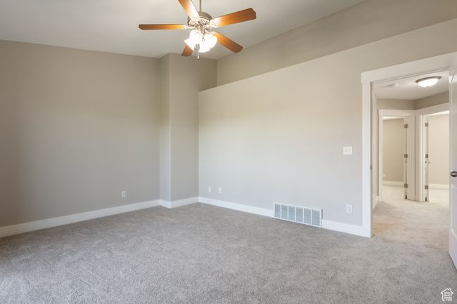 Unfurnished room featuring ceiling fan and carpet floors | Image 13