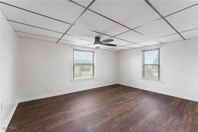 Empty room with plenty of natural light, a drop ceiling, and wood finished floors | Image 17