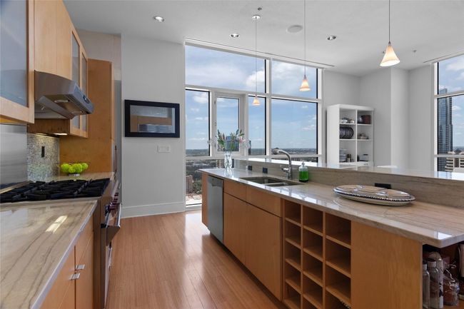 This kitchen is a dream to cook in with high-end appliances and views all around | Image 19