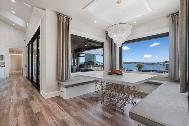 Dining room with wood finished floors, healthy amount of natural light, a chandelier, and recessed lighting | Image 15