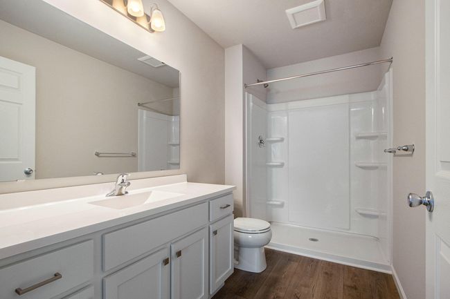 The luxurious primary suite includes a private bath and large walk-in closet. | Image 13