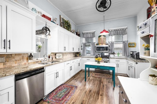 Kitchen with plenty of cabinets blending original features with modern conveniences | Image 8