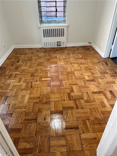 Unfurnished room with parquet floors and radiator | Image 3