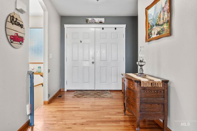 Foyer entrance featuring hardwood finished floors and baseboards | Image 7