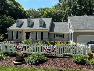 New england style home featuring a garage | Image 2