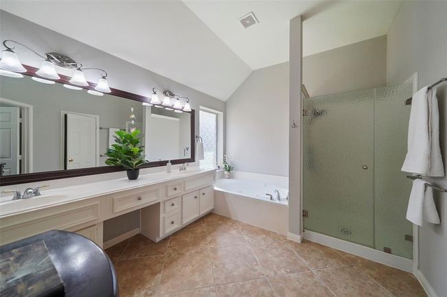 Double sinks, vanity area, soaking tub and large shower all are featured in this primary bath. | Image 18