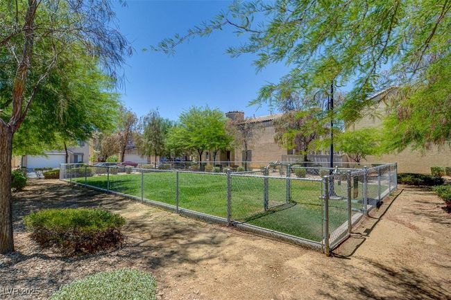 View of property's community with fence, a gate, and a yard | Image 29
