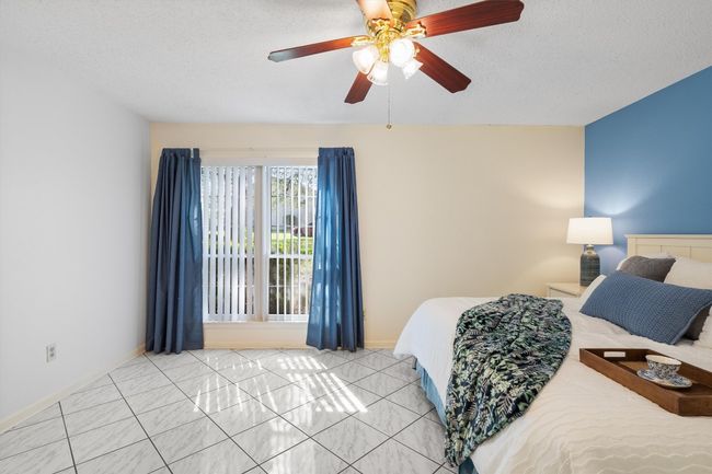 Bedroom featuring a textured ceiling, ceiling fan, and baseboards | Image 18