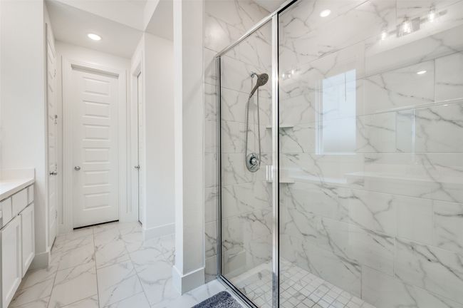 Full bath featuring a marble finish shower, vanity, and recessed lighting | Image 13