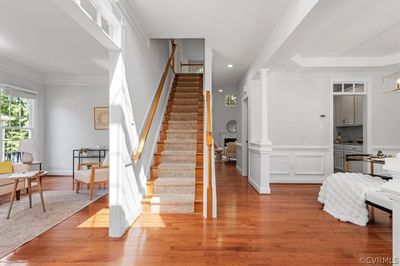 Staircase with ornate columns, wood-type flooring, and ornamental molding | Image 3