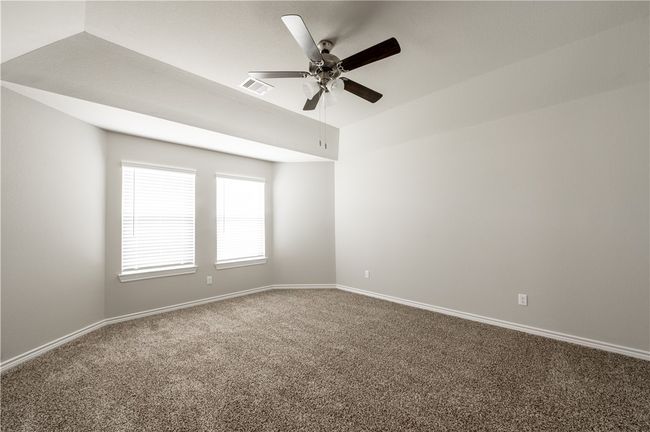 Empty room featuring visible vents, baseboards, carpet, and ceiling fan | Image 14