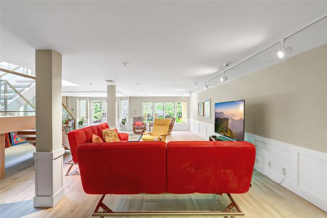 Living area featuring wainscoting, wood finished floors, rail lighting, and a decorative wall | Image 28