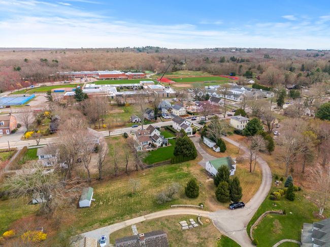 Aerial view of expansive property and accessory buildings. | Image 40
