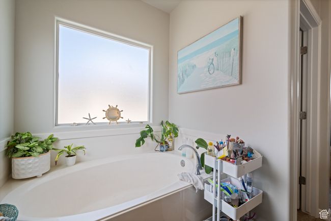 Primary bathroom featuring a sunken tub | Image 22