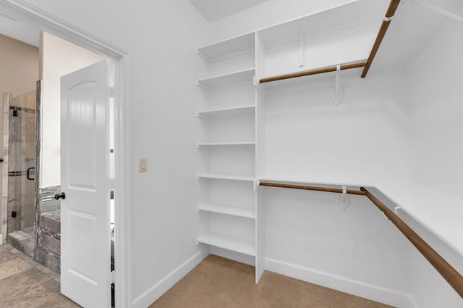 Spacious closet featuring light carpet | Image 23