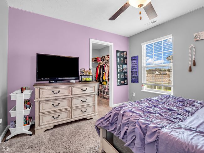bedroom featuring light colored carpet and nice pastels. | Image 36