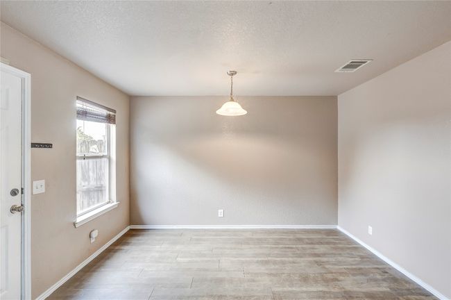 Unfurnished room featuring light wood-type flooring and a textured ceiling | Image 9