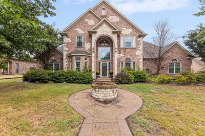 View of front facade with a front lawn and fountain | Image 1