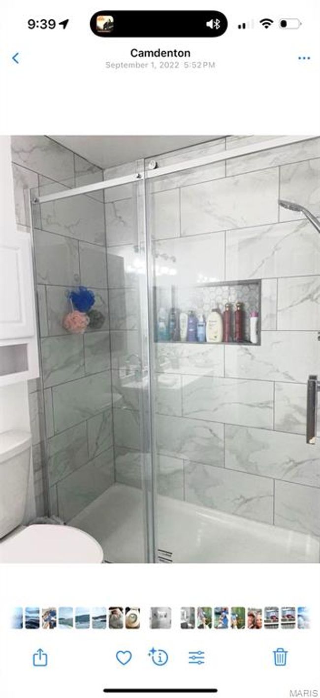 Bathroom with a shower stall and toilet | Image 14