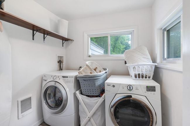 Laundry room featuring heating unit and washer and clothes dryer | Image 30