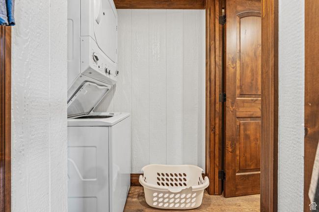 Laundry room featuring stacked washer and dryer | Image 56