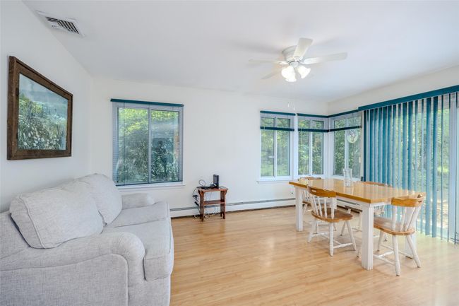 Carpeted bedroom with ceiling fan and a baseboard radiator | Image 21