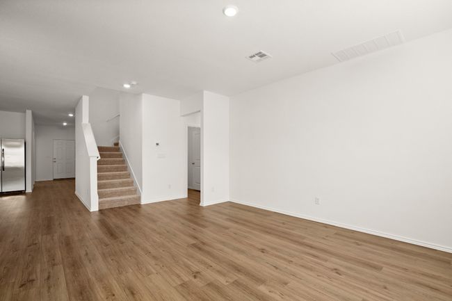Spare room featuring visible vents, stairway, and wood finished floors | Image 9