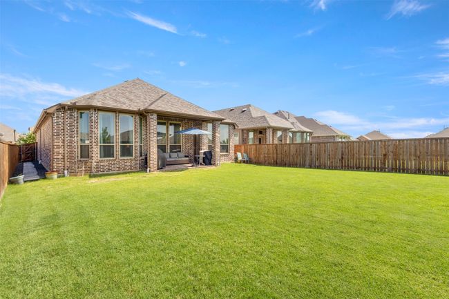 Rear view of property featuring a fenced backyard and brick siding | Image 28