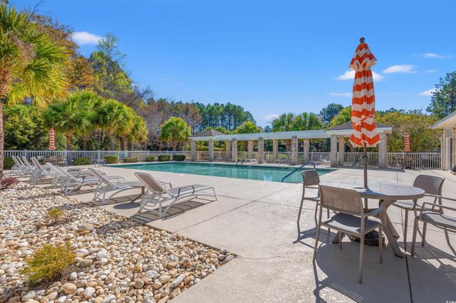 Community pool with a patio and fence | Image 33