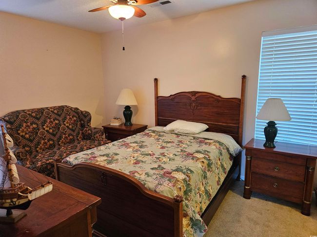 Bedroom with light carpet and ceiling fan | Image 21