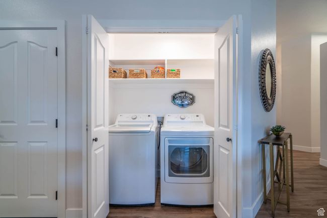 Clothes washing area featuring washer and clothes dryer and dark hardwood / wood-style floors | Image 30
