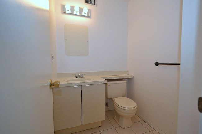 Half bathroom featuring tile patterned flooring, toilet, visible vents, and vanity | Image 18