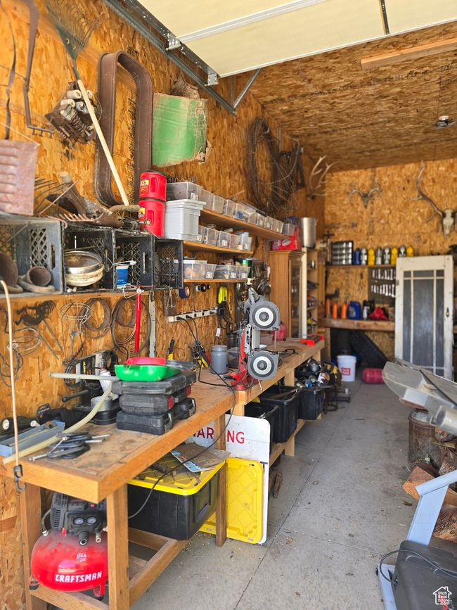 Garage featuring a workshop area | Image 67