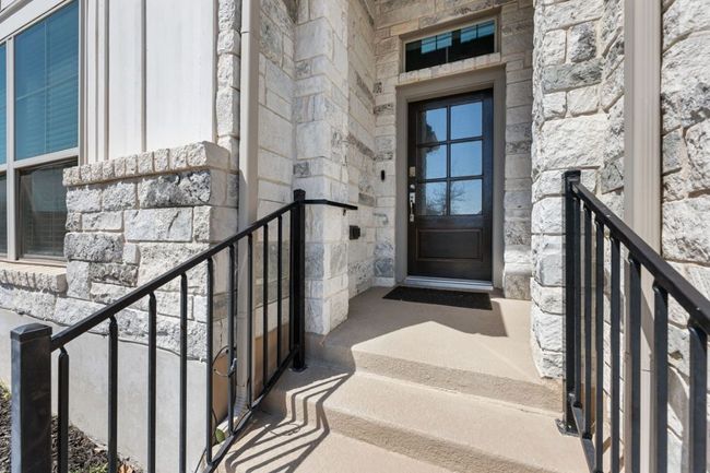 Property entrance featuring stone siding | Image 7
